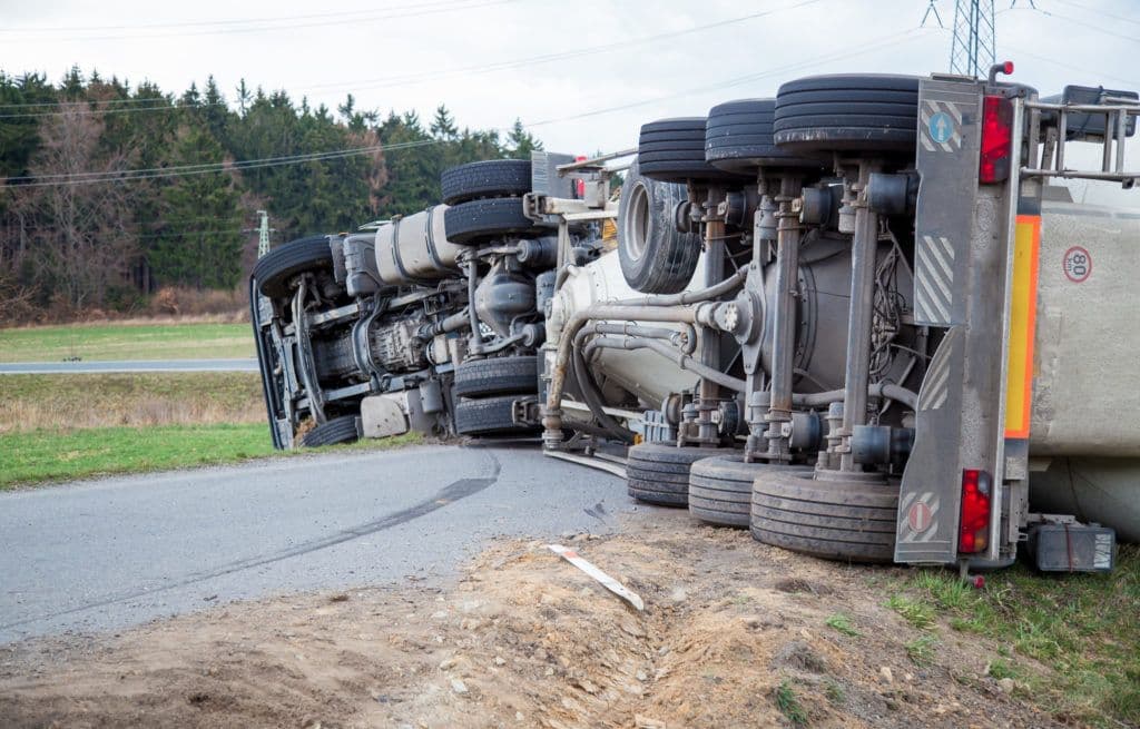 a semi truck that is sitting on its side