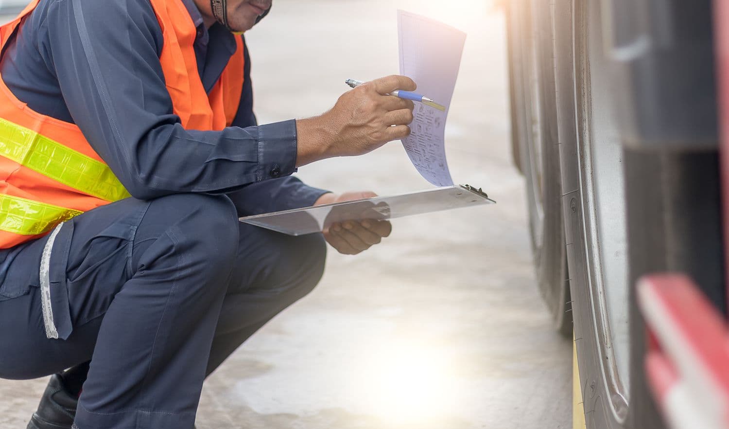a man in a safety vest writing on a piece of paper
