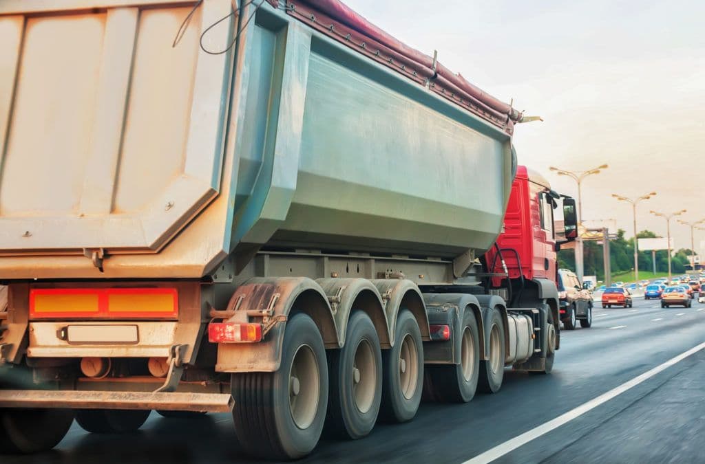 a large truck driving down a city street