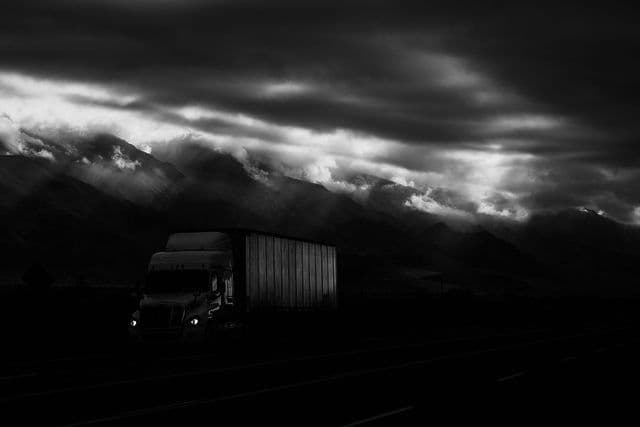 a black and white photo of a semi truck