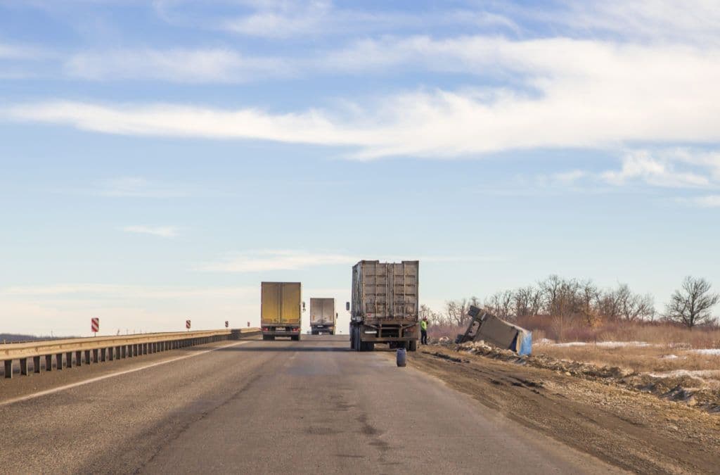 a couple of trucks that are on a road
