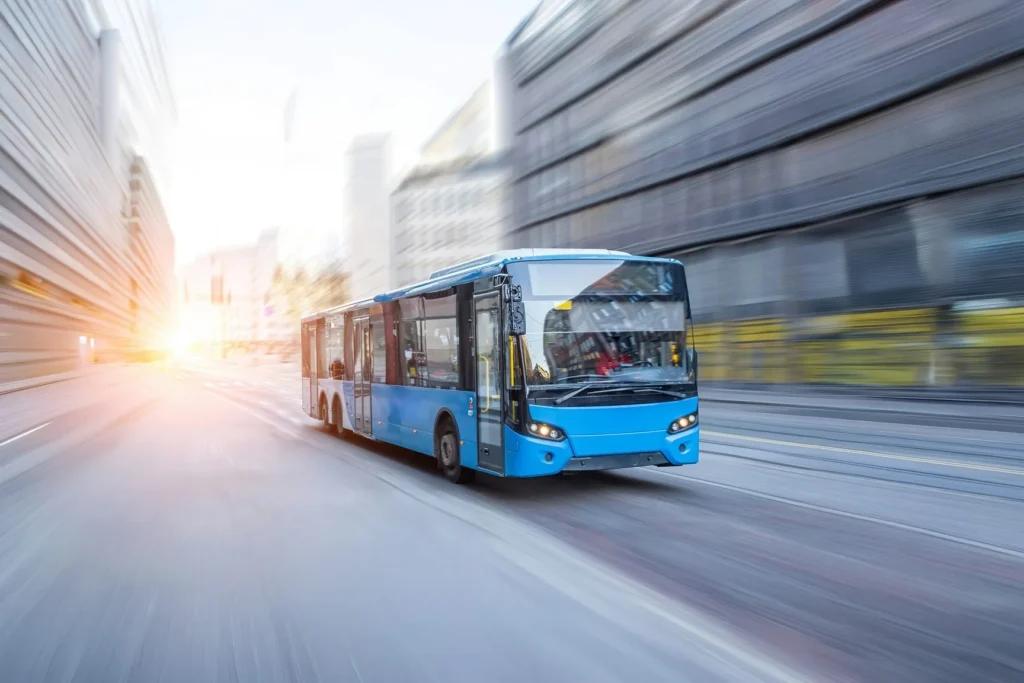 Blue passenger bus driving on a highway in motion
