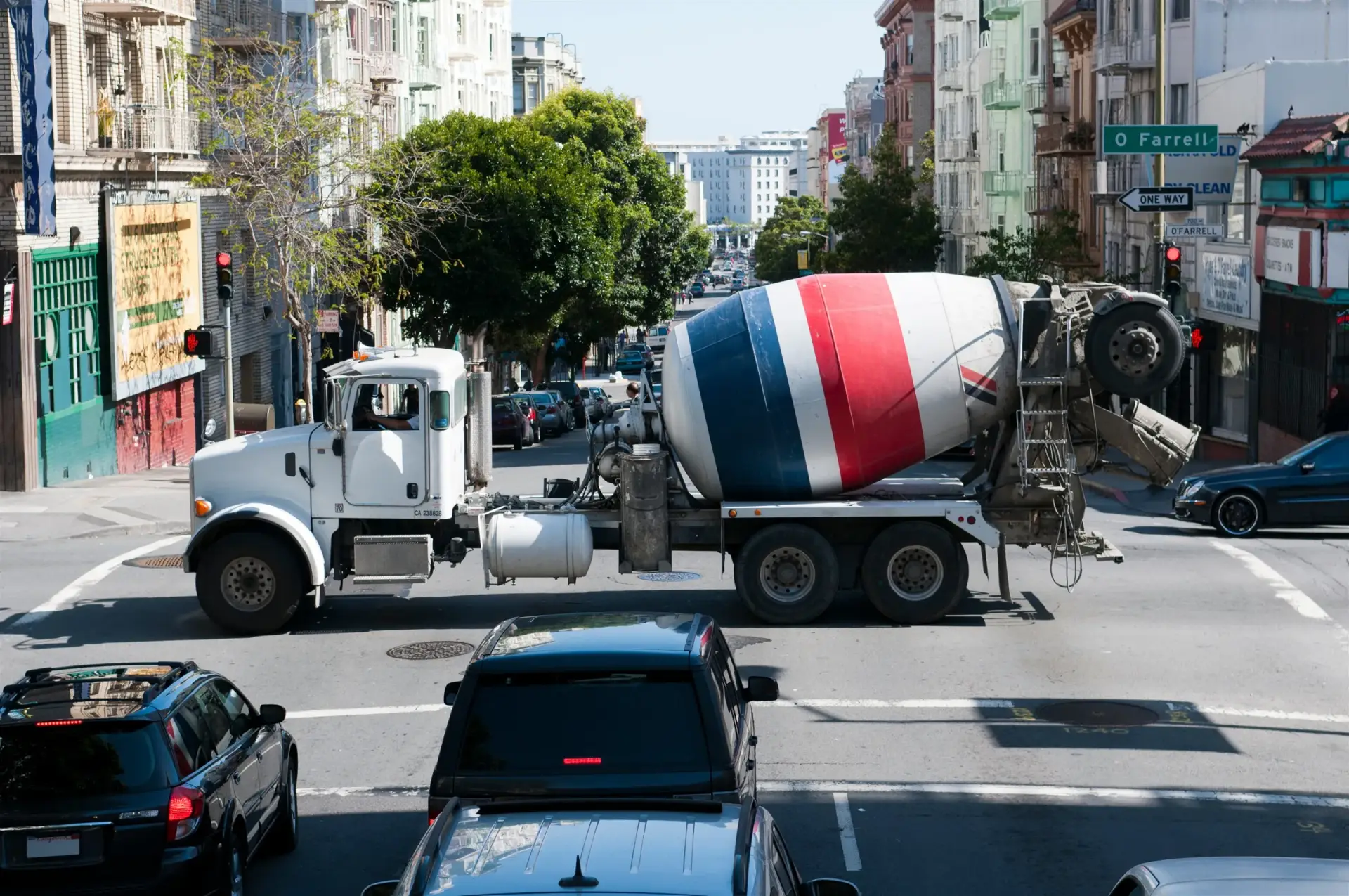 Concrete mixer truck crossing a city intersection