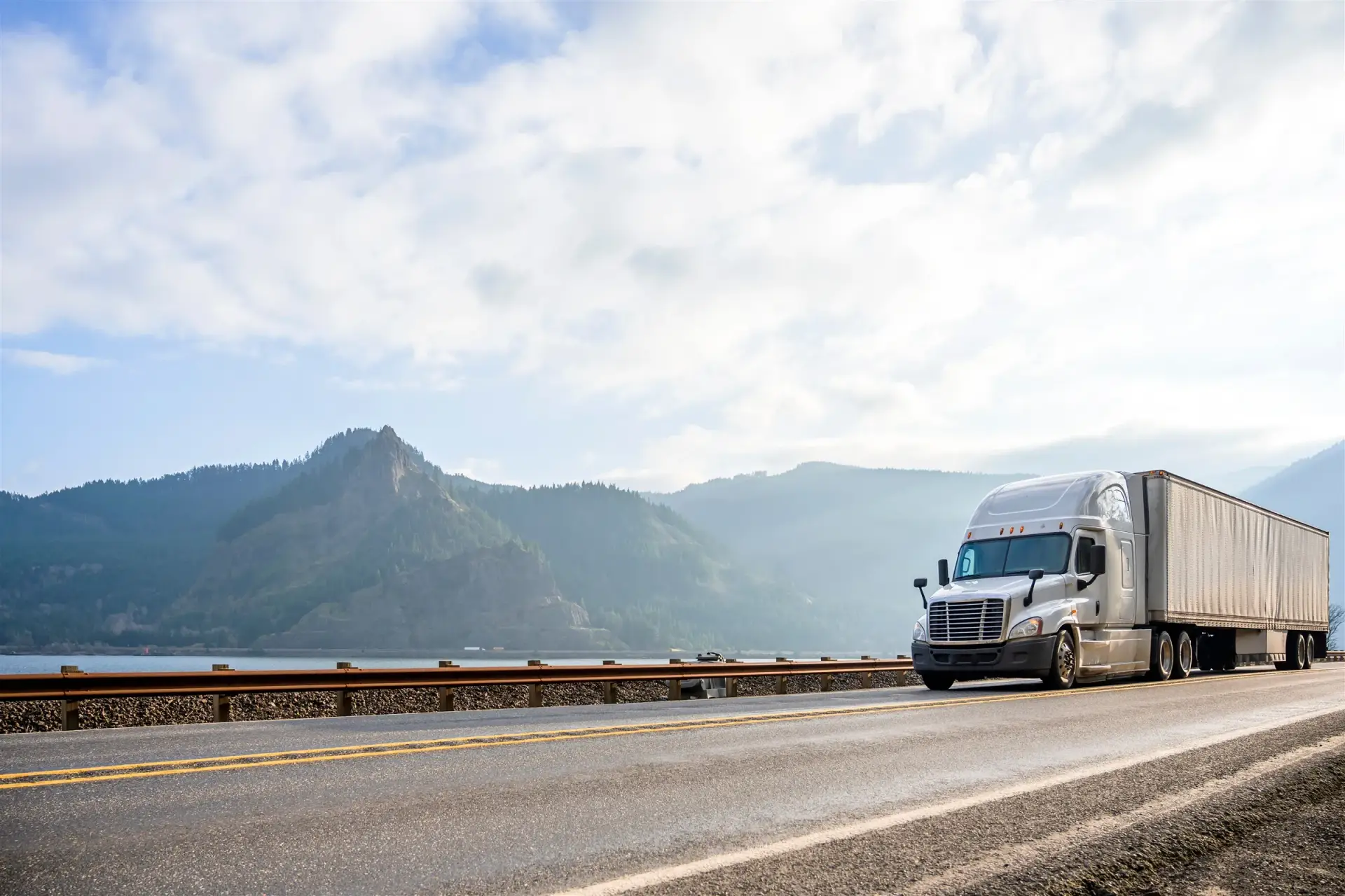 Semi-truck with a dry van trailer on a highway in the Columbia River Gorge